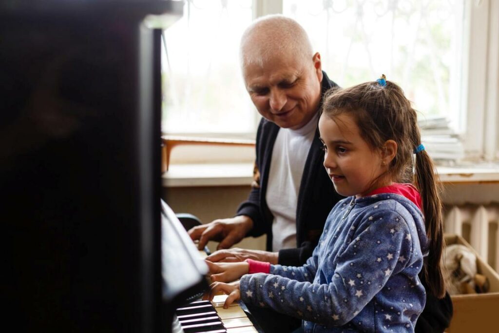 grandfather and granddaughter at the piano