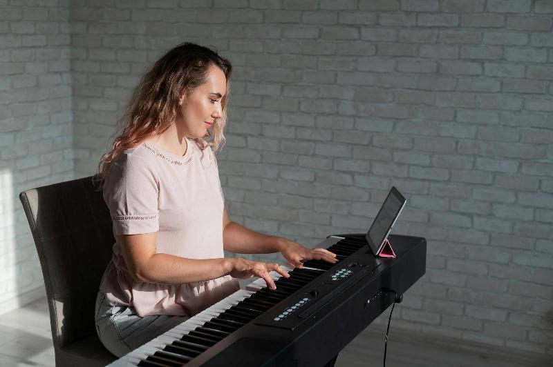 woman playing piano from tablet